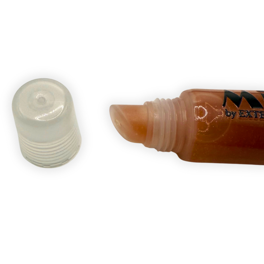 Close-up photo of the Mocha Mirror Gloss applicator tip with the cap removed, showing the smooth angled nozzle and clear tube.