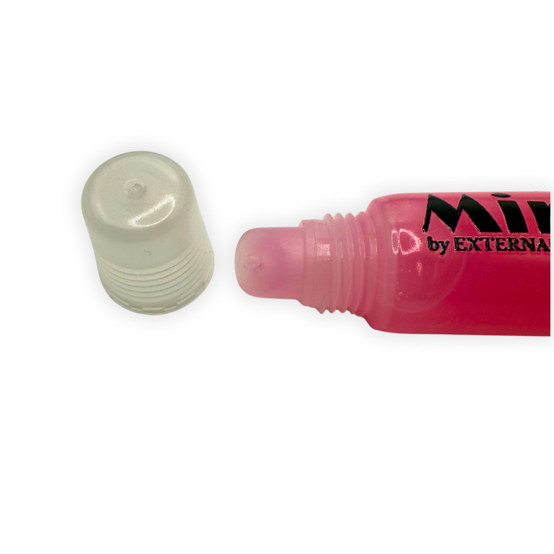 Close-up photo of the Petal Pink Mirror Gloss applicator tip with the cap removed, showing the smooth angled nozzle and clear tube
